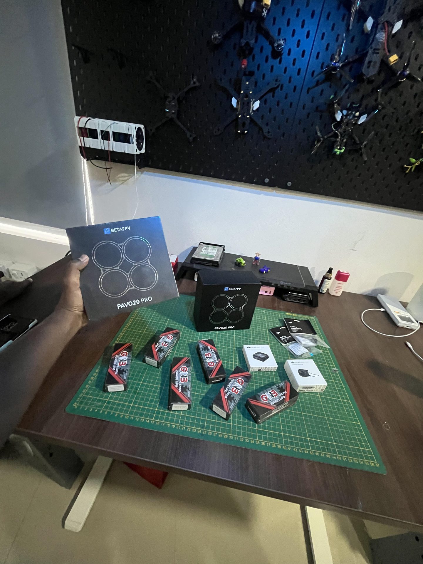 Betafpv Pavo20 Pro unboxing — drone pegboard in background